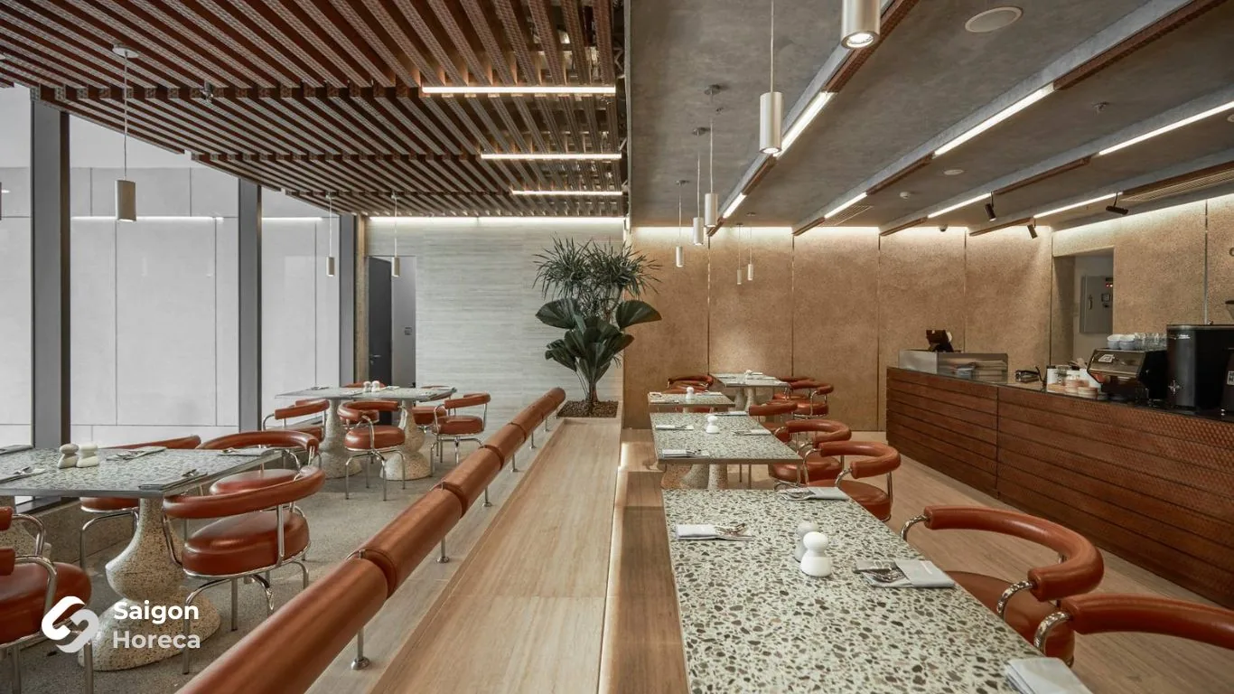 As-built dining room featuring terrazzo tables and brown leather chairs at GodMother Friendship