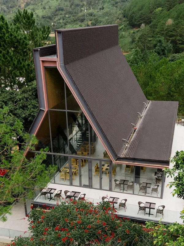 Pitched-roof restaurant architecture nestled among pine canopies
