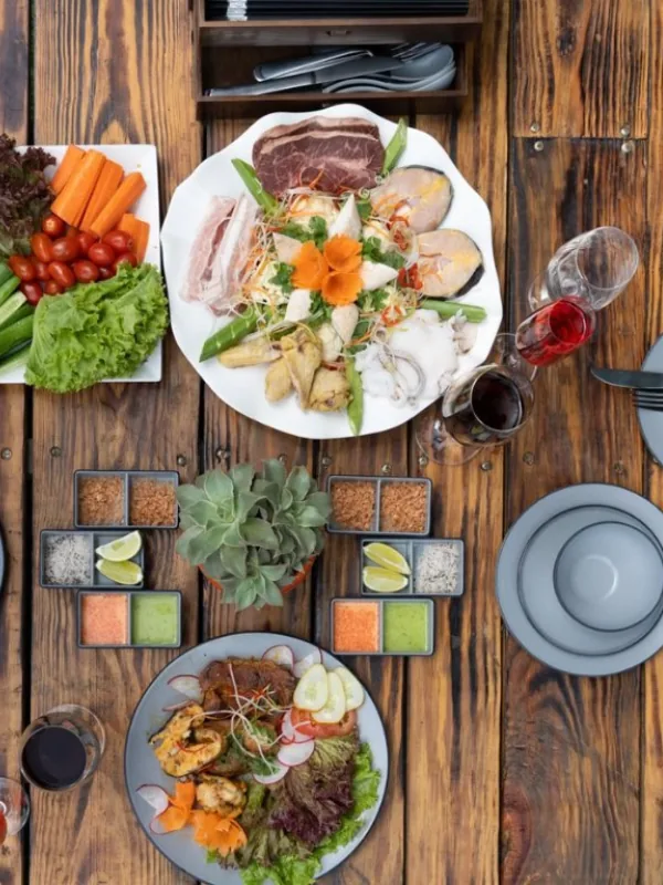 Artfully plated dishes arrayed on a rustic wooden dining table