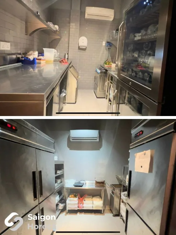 Stainless back-of-house logistics with plating tables, glass-door cabinets, and upright chillers at Little Bear
