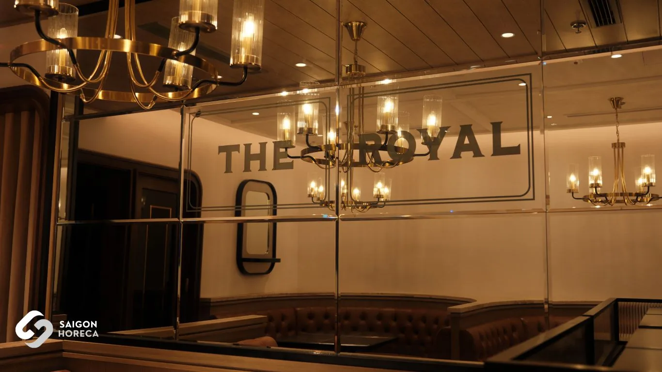 Luxurious diamond-patterned mirror system reflecting the bar space and the 3D logo of The Royal All Day Dining.
