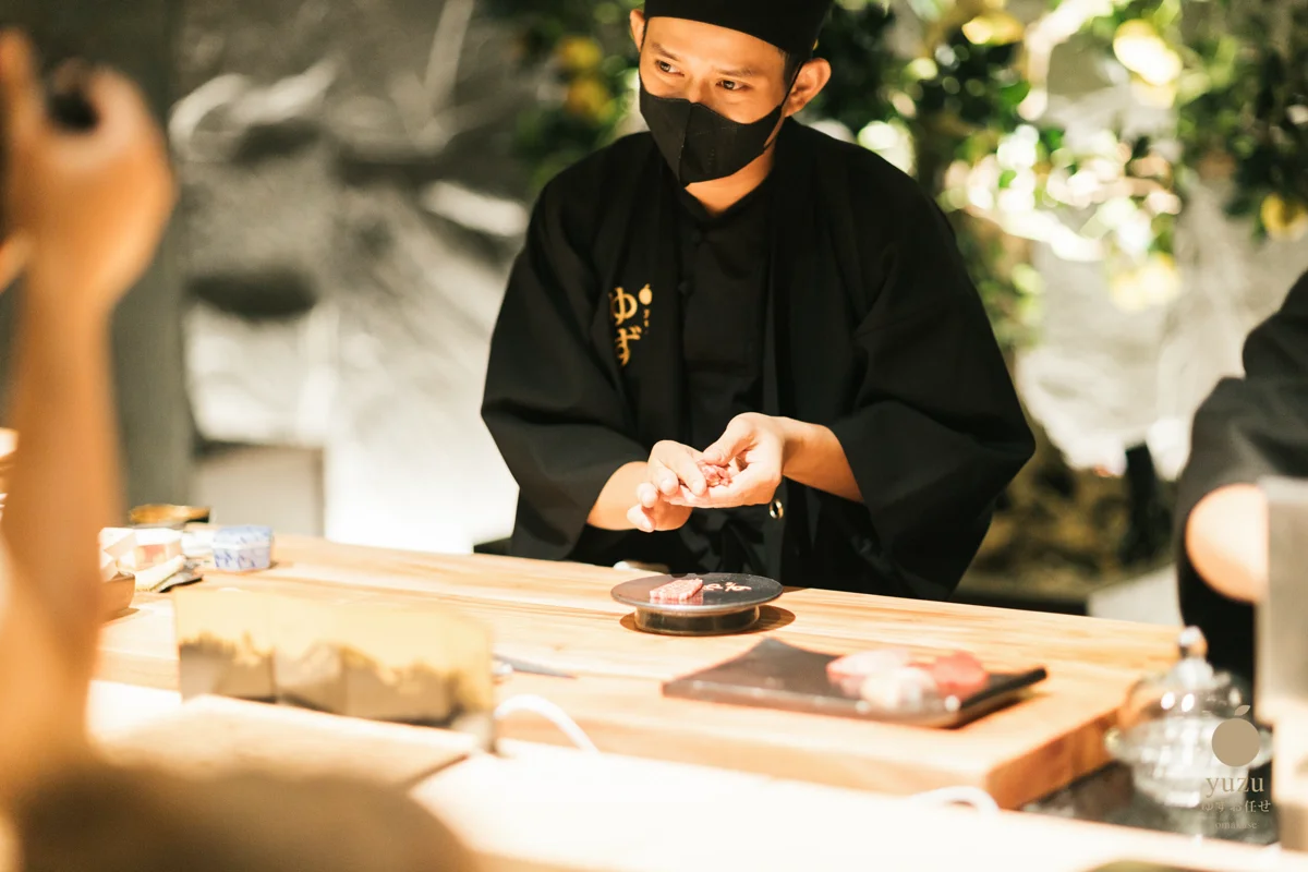Nghệ nhân nặn nigiri sushi thủ công tại quầy gỗ Hinoki Yuzu Omakase